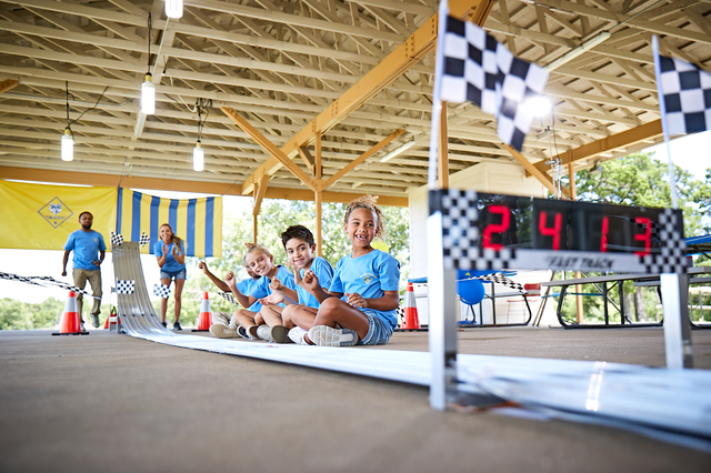 Cub Scouts racing pinewood derby cars.